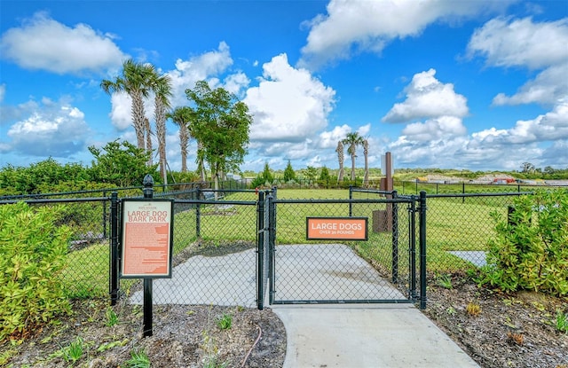 view of gate featuring a yard