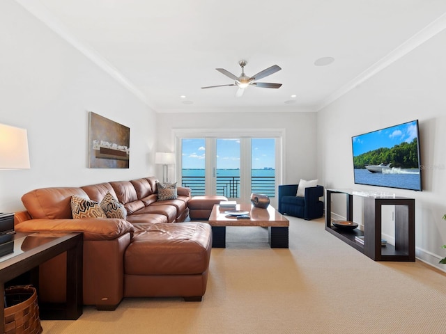 carpeted living room with ceiling fan and ornamental molding