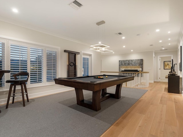 game room with light hardwood / wood-style flooring, ornamental molding, and billiards