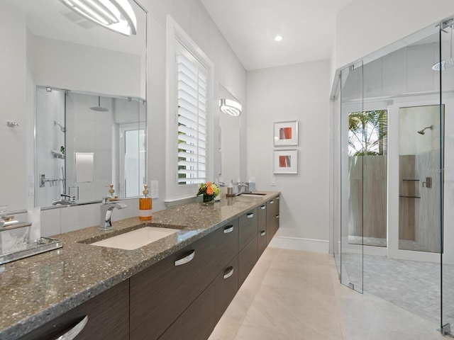 bathroom with tile patterned flooring, vanity, and a shower with door