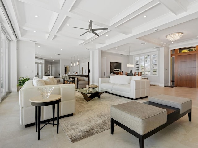 living room featuring ceiling fan with notable chandelier, beamed ceiling, coffered ceiling, and ornamental molding