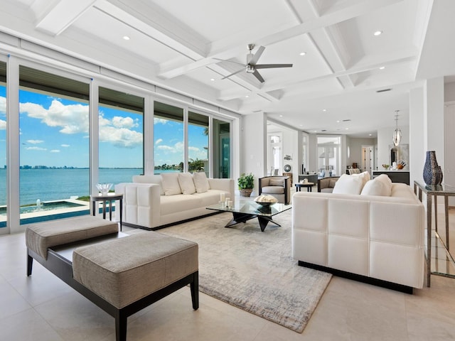 living room featuring beamed ceiling, a water view, and coffered ceiling