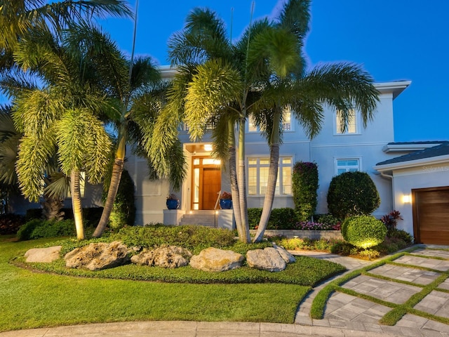 mediterranean / spanish-style house with a front lawn