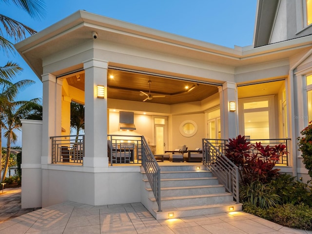 exterior entry at dusk with a porch and ceiling fan