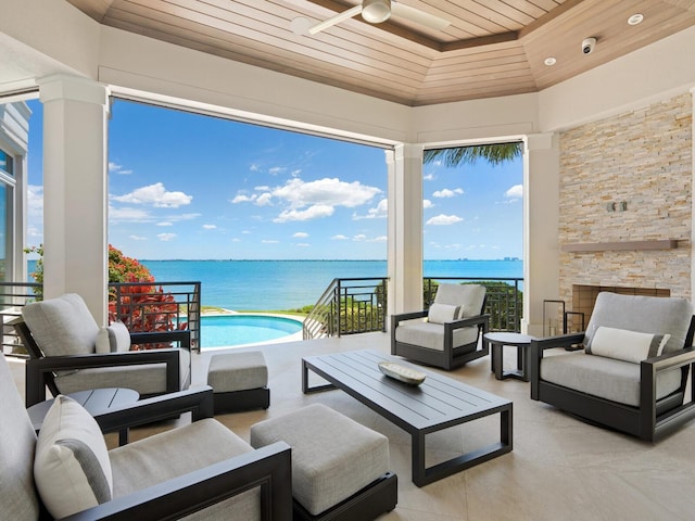 view of patio featuring an outdoor hangout area, a water view, and ceiling fan