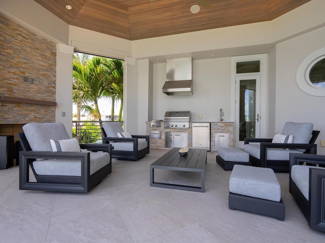 view of patio with area for grilling, an outdoor living space, sink, and exterior kitchen