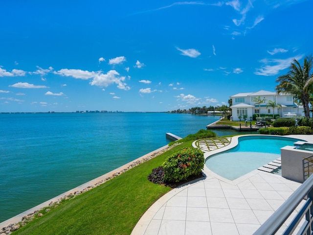 view of pool featuring a yard and a water view