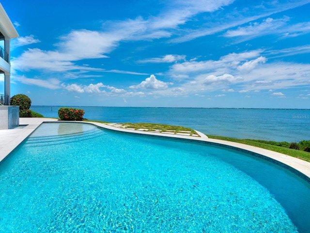 view of pool featuring a water view