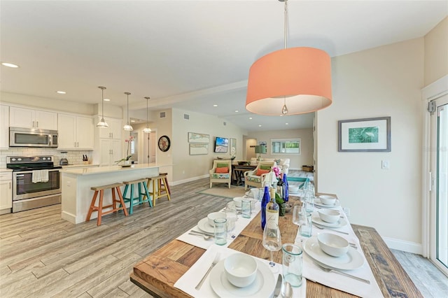 dining area with light hardwood / wood-style flooring