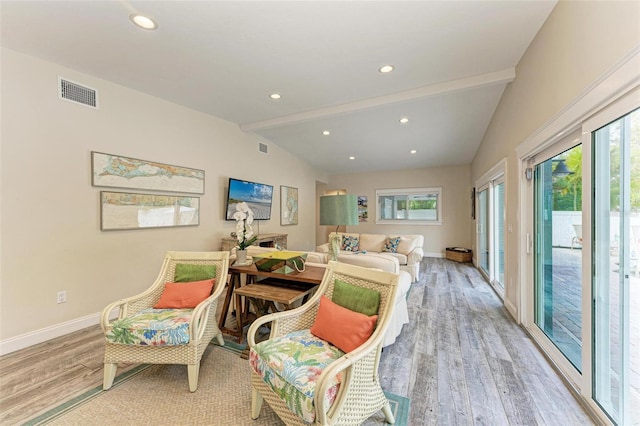 sitting room featuring vaulted ceiling with beams and light hardwood / wood-style flooring