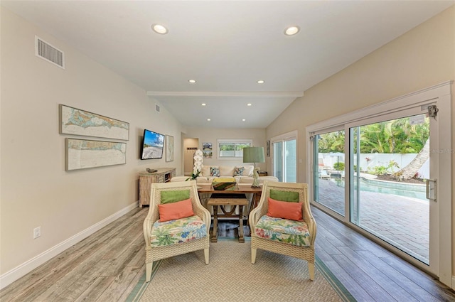 sitting room with vaulted ceiling with beams and light hardwood / wood-style floors