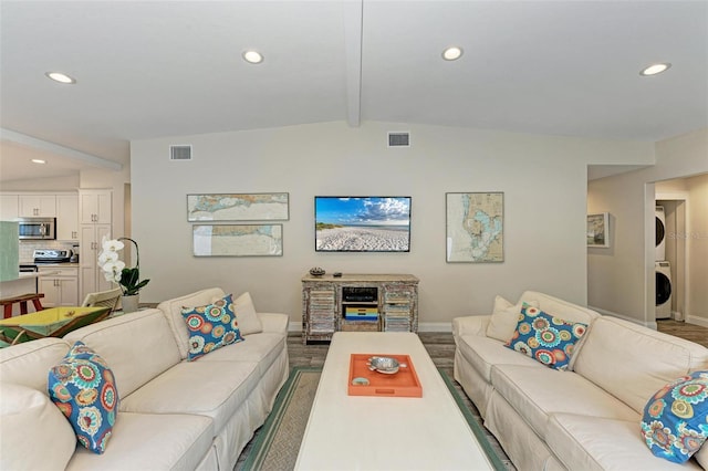 living room with stacked washer and dryer and lofted ceiling with beams