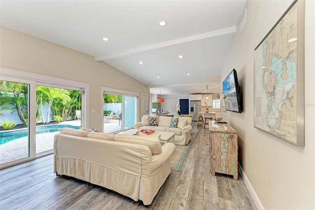 living room featuring hardwood / wood-style flooring and lofted ceiling with beams