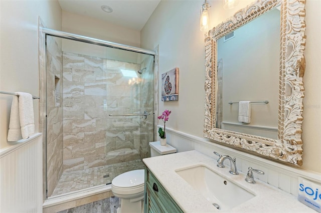 bathroom with vanity, hardwood / wood-style flooring, toilet, and walk in shower