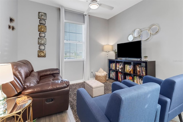 living room featuring hardwood / wood-style floors and ceiling fan