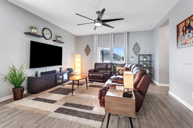 living room featuring ceiling fan and wood-type flooring