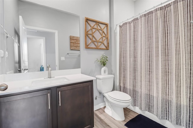 bathroom featuring hardwood / wood-style floors, vanity, and toilet