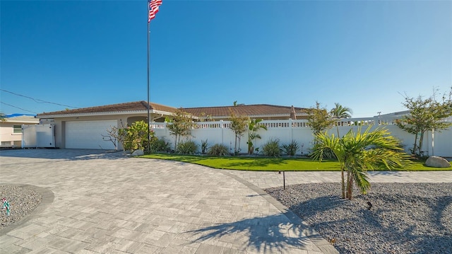 view of front facade featuring a front lawn and a garage