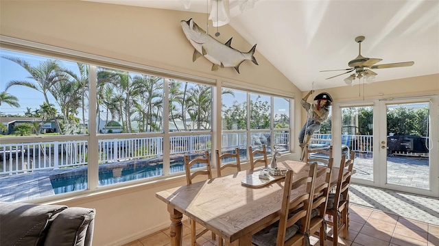 sunroom / solarium featuring ceiling fan, french doors, and lofted ceiling