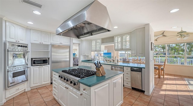 kitchen featuring stainless steel appliances, white cabinets, and exhaust hood