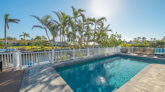 view of pool with a wooden deck and a patio