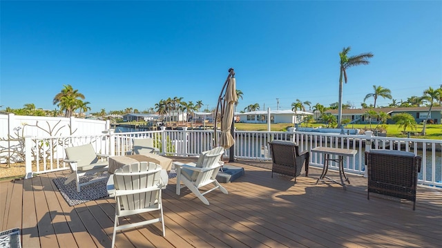 wooden deck featuring a water view