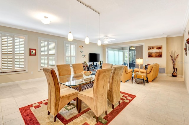 dining space featuring ceiling fan, crown molding, and light tile patterned floors