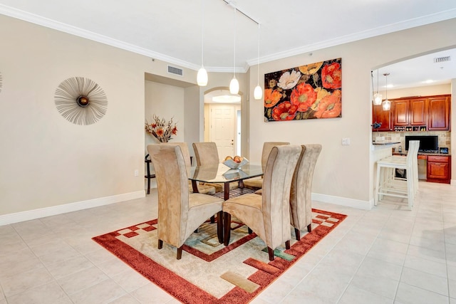 dining area featuring light tile patterned floors, rail lighting, and ornamental molding