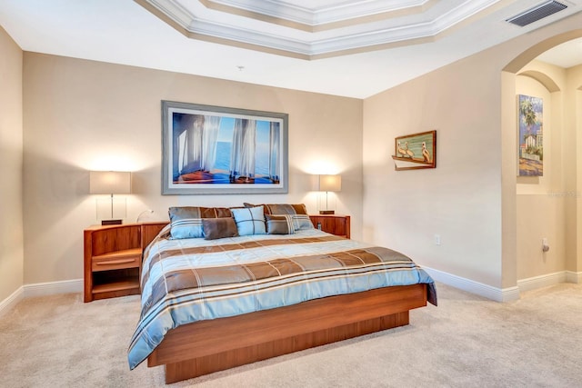 carpeted bedroom with a raised ceiling and crown molding