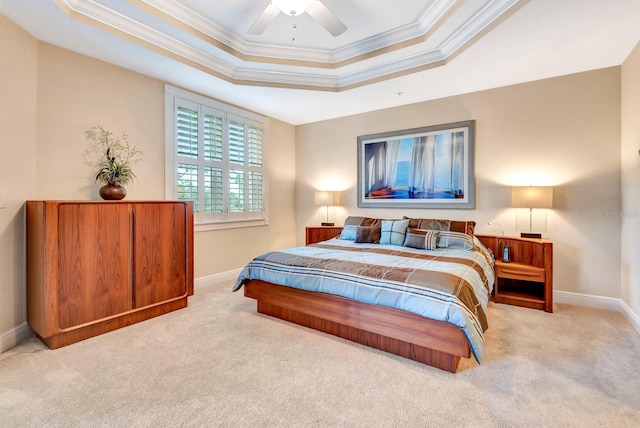 bedroom with ceiling fan, a raised ceiling, ornamental molding, and light carpet