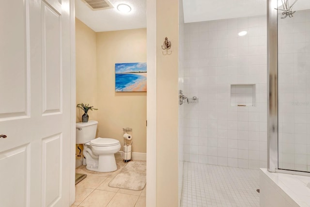 bathroom with tiled shower, tile patterned flooring, a textured ceiling, and toilet