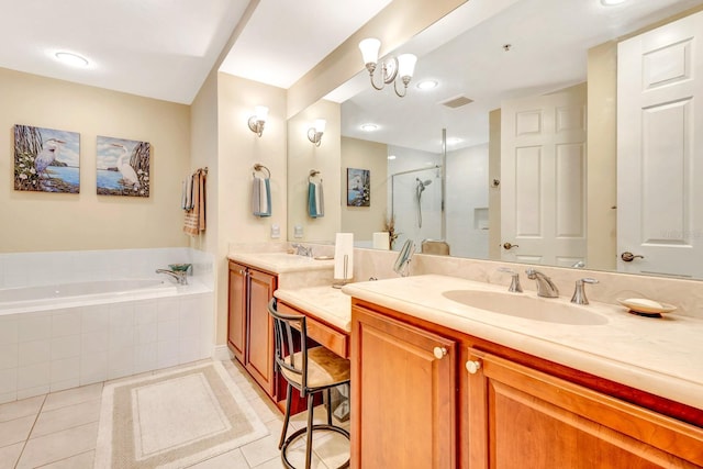 bathroom with tile patterned flooring, vanity, a chandelier, and independent shower and bath