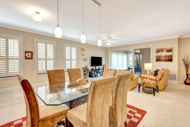 dining room with ceiling fan, light tile patterned floors, and ornamental molding