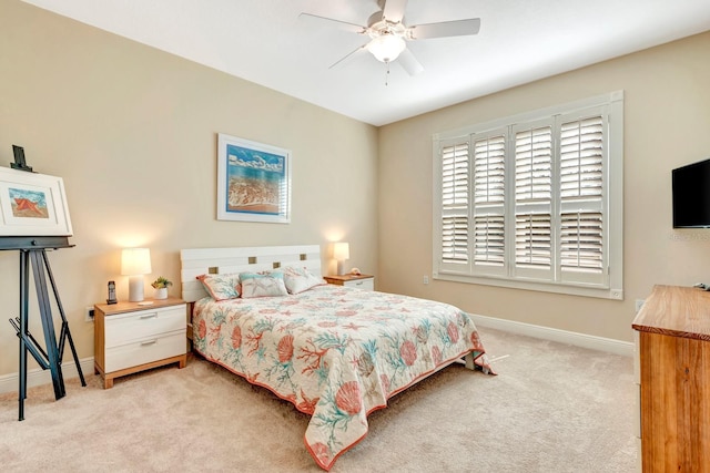 bedroom with ceiling fan and light carpet