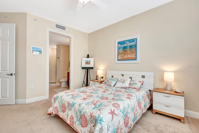 carpeted bedroom featuring ensuite bath and ceiling fan