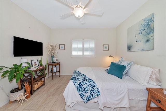 bedroom with light hardwood / wood-style flooring and ceiling fan