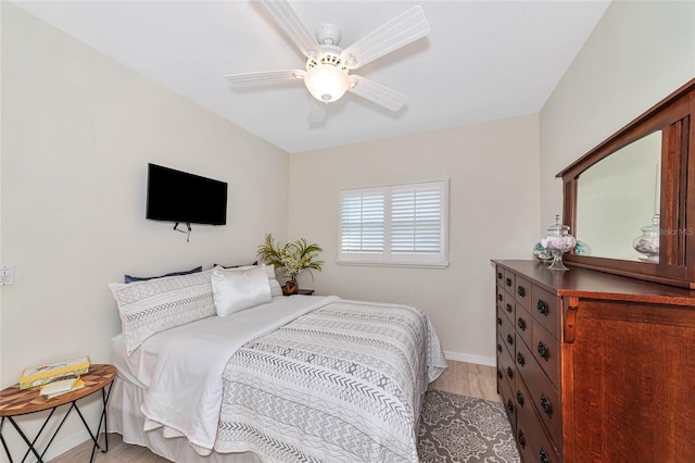 bedroom with ceiling fan and light hardwood / wood-style floors