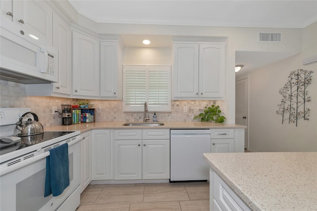 kitchen with white cabinetry, white appliances, sink, and tasteful backsplash