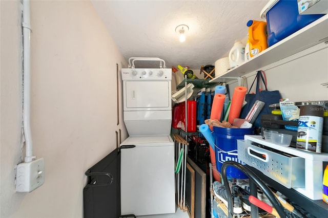 washroom with stacked washer and clothes dryer