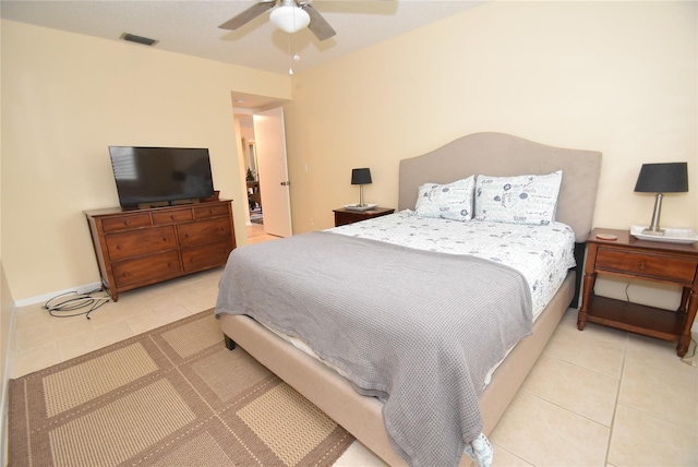 bedroom with ceiling fan and light tile patterned floors