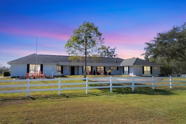 single story home featuring a fenced front yard and a lawn