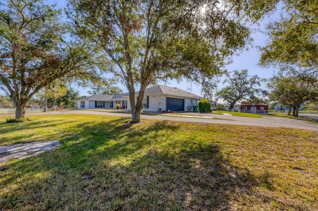 single story home with a front lawn and a garage