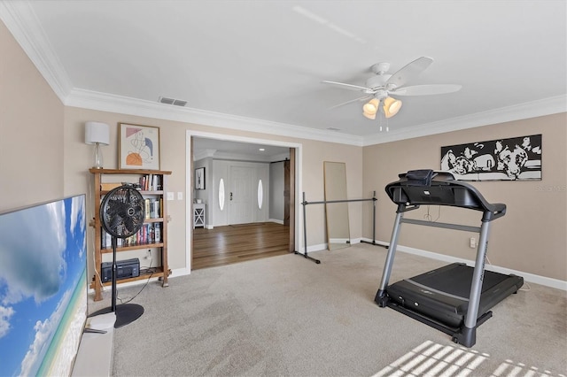 exercise area with ceiling fan, ornamental molding, and light carpet