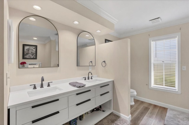 bathroom featuring vanity, toilet, wood-type flooring, and crown molding