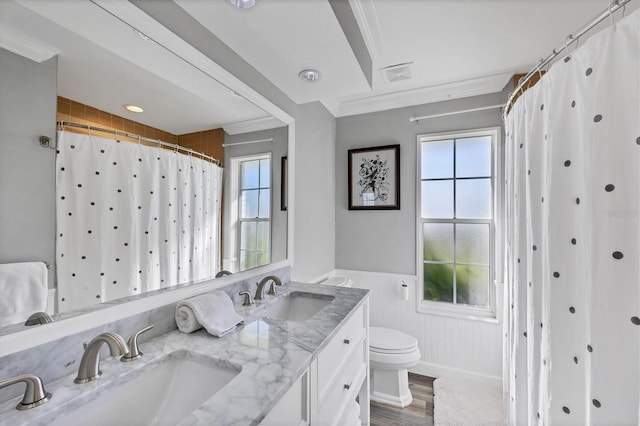 bathroom featuring hardwood / wood-style flooring, vanity, toilet, and crown molding