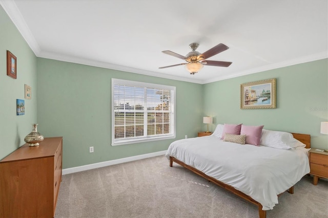 carpeted bedroom with ceiling fan and ornamental molding