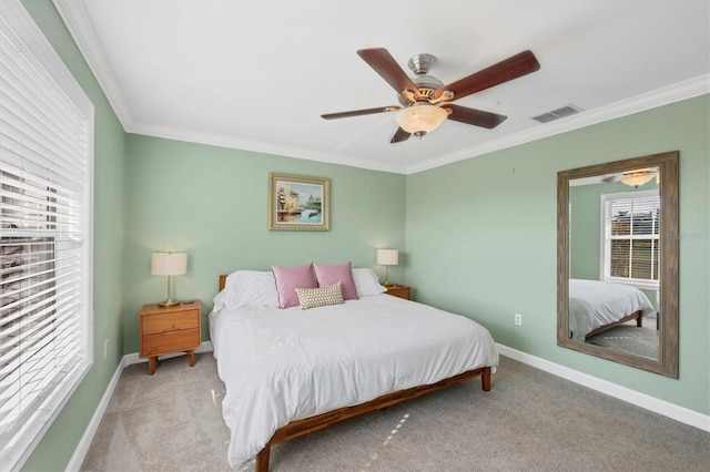 bedroom featuring ceiling fan, ornamental molding, and light carpet