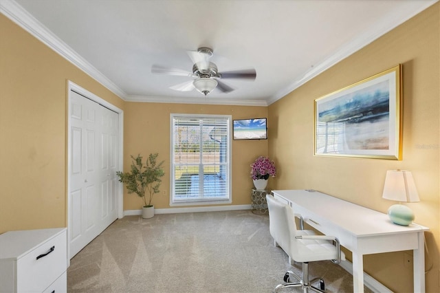 office area featuring ceiling fan, ornamental molding, and light carpet