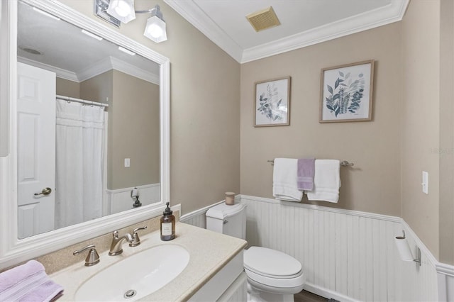 bathroom featuring vanity, toilet, and ornamental molding