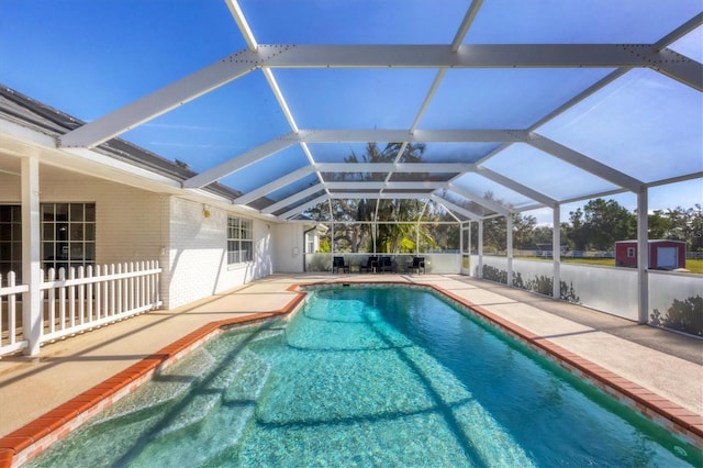 view of swimming pool featuring a patio area and a lanai